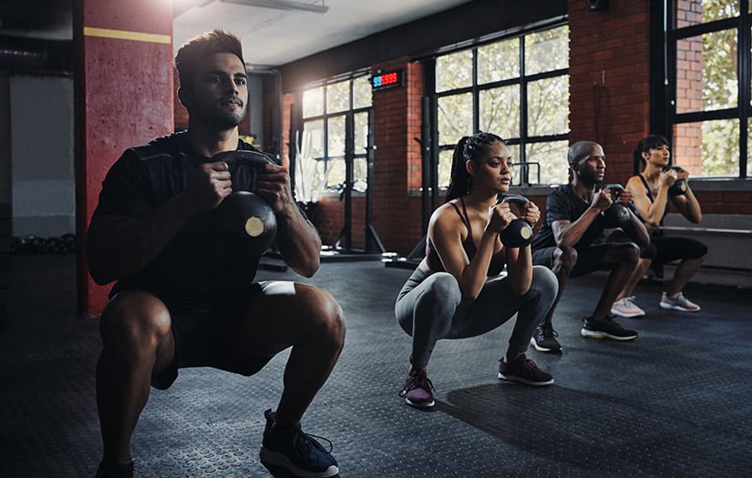 Participants practicing coordinated warm-up drills in a bright studio